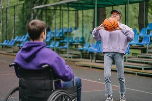 A young person passing a basketball to another young person