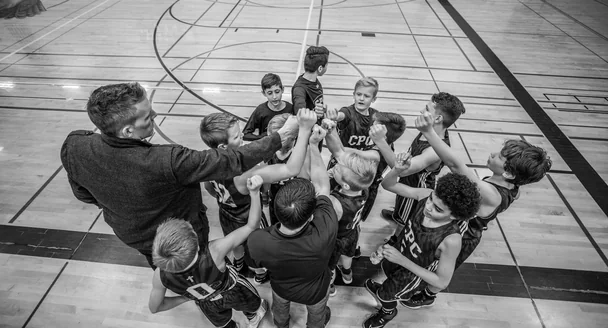 Young people playing a basketball match