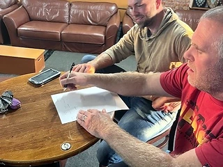 Two attendees working through a written exercise during the session
