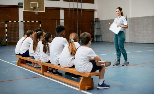 A coach talking with a class of young people