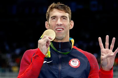 Michael Phelps celebrating with his gold medals at the 2016 Olympics